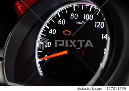 Check Engine Light Close Up, A car speedometer with an illuminated orange check engine light 127811669