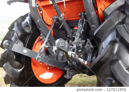 The farm tractor lifting arm or a three-point hitch lift is used to connect agricultural implements The farm tractor lifting arm or a three-point hitch lift is used to connect agricultural implements 127811958