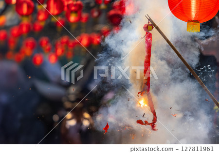 Traditional Chinese firecrackers are exploding with flashes and smoke in Lunar new year. 127811961
