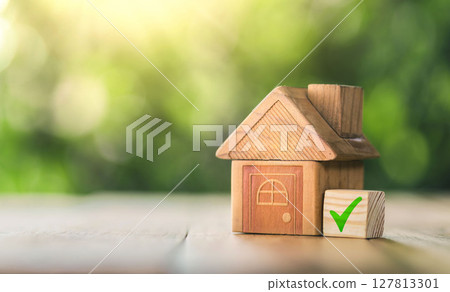 Mortgage and loan approved concept: Wooden model house place on the table. planning savings money of coins to buy a home concept for property, mortgage and real estate investment. Mortgage and loan approved concept: Wooden model house place on the table. planning savings money of coins to buy a home concept for property, mortgage and real estate investment. 127813301