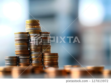 a clean image of coins stacked beside a label wealth building 127813972