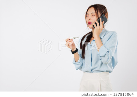 Asian woman feeling worried and sick talks on phone to her doctor about her disease and temperature while checking the thermometer making a call to discuss how sick she is, isolated white background Asian woman feeling worried and sick talks on phone to her doctor about her disease and temperature while checking the thermometer making a call to discuss how sick she is, isolated white background 127815064