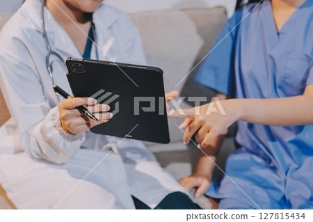 A doctor uses a stethoscope to check the heartbeat of his patient. Patients must undergo a yearly check-up for their health or a check-up from a cardiologist. 127815434