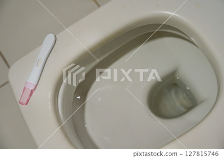 Pregnancy test on the toilet. Pregnancy test on the toilet. 127815746