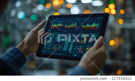 factory manager analyzing IoT sensor data via tablet 127816022