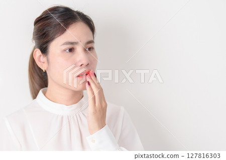 Business woman having Mouth ache for concepts of Mouth Ulcer Sore, Aphthous Stomatitis, Oral Lesions, Halitosis, Oral Health Care, Toothache and Gum Disease, Dental Caries, Gingivitis and Periodontal Business woman having Mouth ache for concepts of Mouth Ulcer Sore, Aphthous Stomatitis, Oral Lesions, Halitosis, Oral Health Care, Toothache and Gum Disease, Dental Caries, Gingivitis and Periodontal 127816303