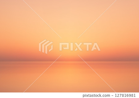 Peaceful sunset gradient sky over calm water horizon Peaceful sunset gradient sky over calm water horizon 127816981