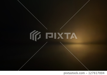Soft golden haze in dark cinematic studio light 127817004
