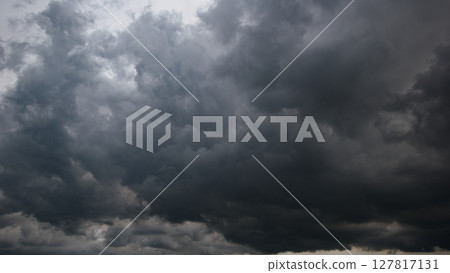 The dark sky, heavy with swirling clouds, signals an impending windstorm, highlighting the dramatic changes in weather and the immense power of nature. The dark sky, heavy with swirling clouds, signals an impending windstorm, highlighting the dramatic changes in weather and the immense power of nature. 127817131