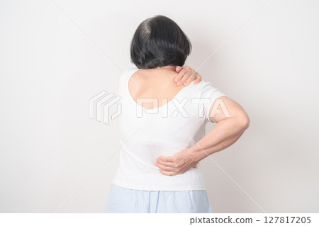 Elderly woman having back body ache for concepts of Back Muscle Strain, Piriformis Syndrome, Low Back Pain, Lumbar Disc Degeneration, Herniated, Osteoporosis, Spinal Compression and Health care Elderly woman having back body ache for concepts of Back Muscle Strain, Piriformis Syndrome, Low Back Pain, Lumbar Disc Degeneration, Herniated, Osteoporosis, Spinal Compression and Health care 127817205