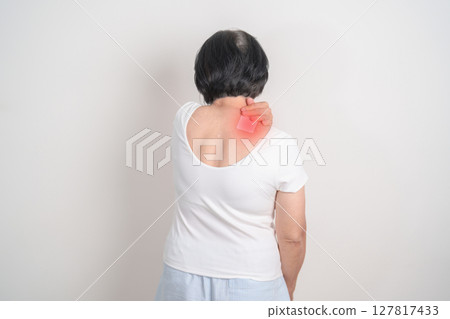 Elderly Woman having Shoulder Pain with Medicated pain relief patch plaster for Muscle Inflammation and Sprain, Myofascial ache syndrome and Fibromyalgia, Shoulder Myalgia and Scapular Tightness Elderly Woman having Shoulder Pain with Medicated pain relief patch plaster for Muscle Inflammation and Sprain, Myofascial ache syndrome and Fibromyalgia, Shoulder Myalgia and Scapular Tightness 127817433