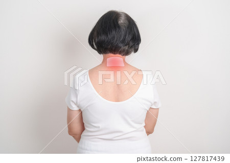 Elderly Woman having Neck pain with Medicated pain relief patch plaster for Neck Muscle Strain and Inflammation, Myofascial pain syndrome and Fibromyalgia, Rheumatism and Cervical Spine Spondylosis 127817439