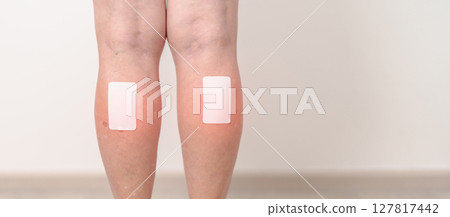 Elderly woman having Calf pain with Medicated pain relief patch plaster for concepts of Calf Muscle Strain, muscle pull, Leg Cramp, Sprain, aches, Varicose Veins, Deep Vein and world Thrombosis day Elderly woman having Calf pain with Medicated pain relief patch plaster for concepts of Calf Muscle Strain, muscle pull, Leg Cramp, Sprain, aches, Varicose Veins, Deep Vein and world Thrombosis day 127817442