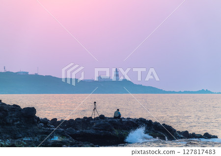 Photographer Captures Shimen Sunset with Fuguijiao Lighthouse New Taipei City. 127817483