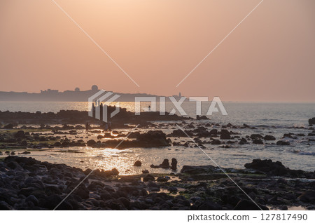 Spring Sunset Crowd at Fugui Cape Lighthouse in Shimen, New Taipei City, Taiwan. 127817490