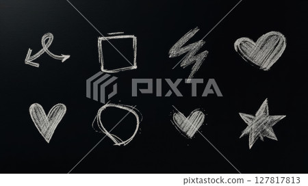 Colorful chalk doodles of different shapes and symbols are drawn on a blackboard, capturing the artistic spirit during a creative workshop. 127817813