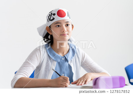 A student studying while wearing a victory headband 127817852