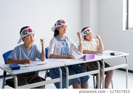 Students posing in victory poses at cram school 127817853