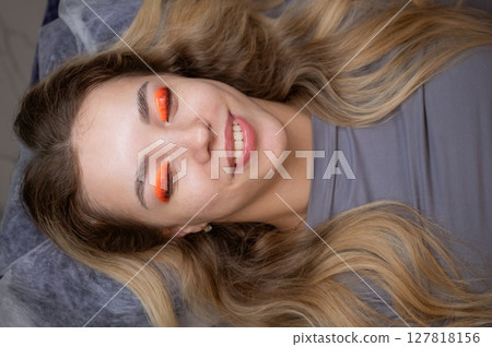 Caucasian woman undergoing eyelash lamination procedure. Top view.  127818156