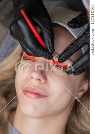 Caucasian woman undergoing eyelash lamination procedure.  127818166