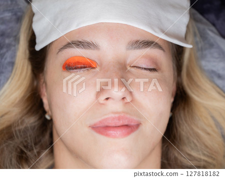 Caucasian woman undergoing eyelash lamination procedure. Top view.  127818182