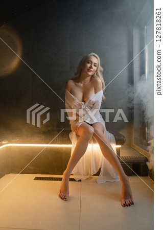 Relaxation moment in sauna with a woman enjoying her time Relaxation moment in sauna with a woman enjoying her time 127818261