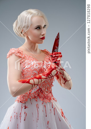 Bridal elegance meets horror in a striking studio portrait 127818298