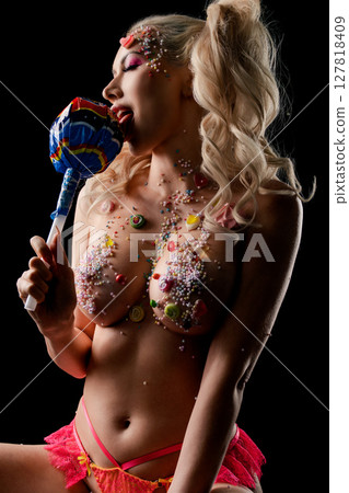 Expressive beauty featuring body art and vibrant candy-inspired elements Expressive beauty featuring body art and vibrant candy-inspired elements 127818409