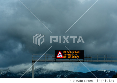 The road sign in Spanish reminds drivers to keep a safe distance on a cloudy day. The road sign in Spanish reminds drivers to keep a safe distance on a cloudy day. 127819185