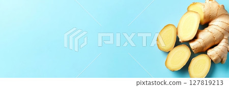 Fresh ginger root and several slices are arranged on a vibrant blue background. Creating a visually appealing image that promotes a healthy lifestyle and highlights the medicinal properties of ginger 127819213