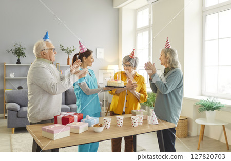 Nurse Organizing Birthday Celebration For Elderly Patients At Nursing Home 127820703