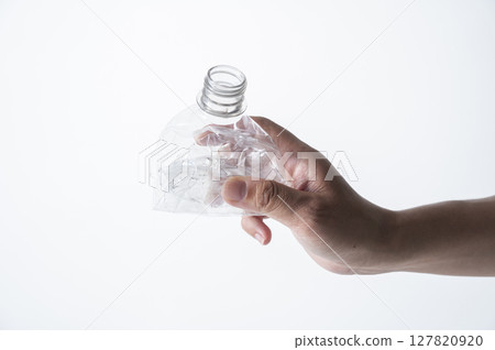 Man's hand holding a crushed plastic bottle Man's hand holding a crushed plastic bottle 127820920