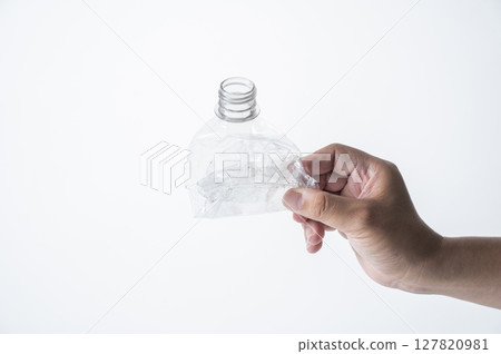 Man's hand holding a crushed plastic bottle Man's hand holding a crushed plastic bottle 127820981