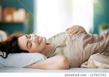 Woman is sleeping in her bedroom 127821301