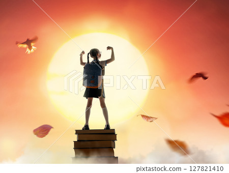 child on the tower of books 127821410