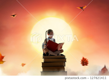 child on the tower of books child on the tower of books 127821411