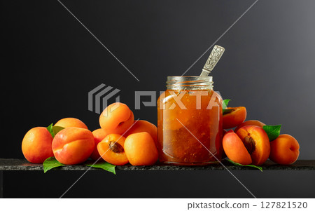 Apricot jam in glass jar and fresh fruits. 127821520