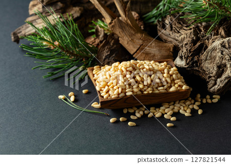 Peeled pine nuts with cedar dried snags and green branches. 127821544