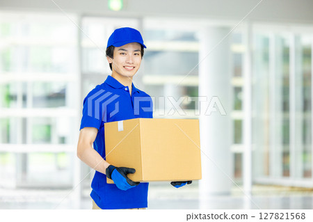 Male delivery man carrying luggage Male delivery man carrying luggage 127821568