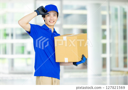 Male delivery man carrying luggage 127821569