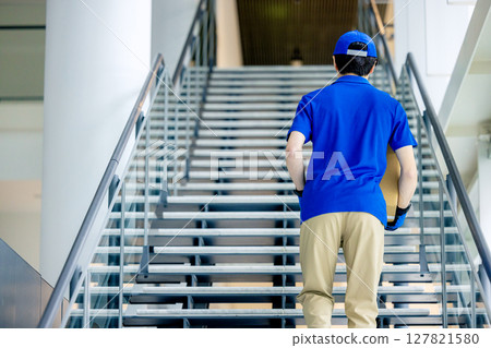 Male delivery man carrying luggage Male delivery man carrying luggage 127821580
