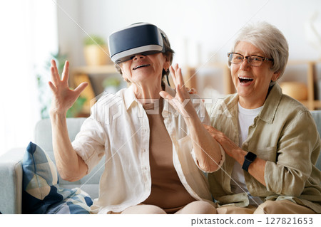 women playing console games wearing vr goggles 127821653