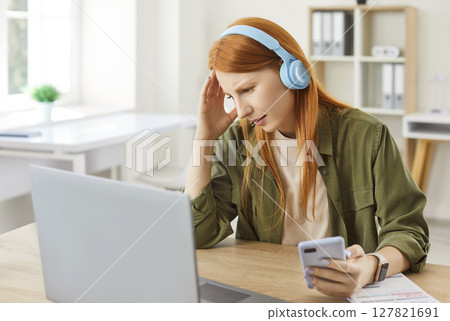 Upset Woman Working From Home, Reacting To Bad News On Her Phone 127821691
