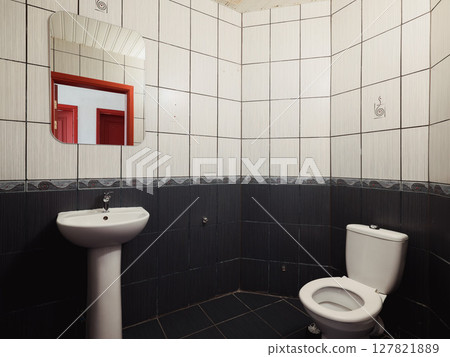 This bathroom features a simple modern design with contemporary fixtures in neutral colors 127821889