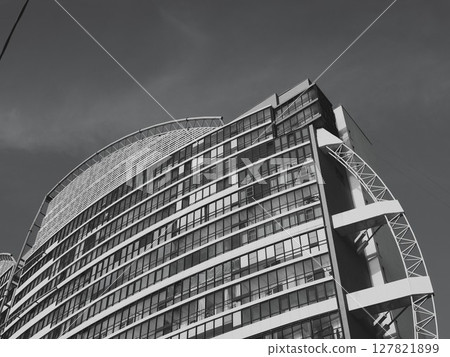Modern Architectural Design of a Tall Skyscraper Presented in Striking Black and White Contrast Modern Architectural Design of a Tall Skyscraper Presented in Striking Black and White Contrast 127821899