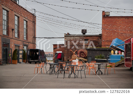 Urban Outdoor Dining Area Featuring Beautiful and Artistic Murals Alongside Food Trucks 127822016