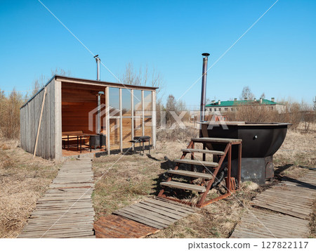 A Rustic Outdoor Retreat featuring a charming Wooden Cabin and a relaxing Bathing Area to enjoy A Rustic Outdoor Retreat featuring a charming Wooden Cabin and a relaxing Bathing Area to enjoy 127822117