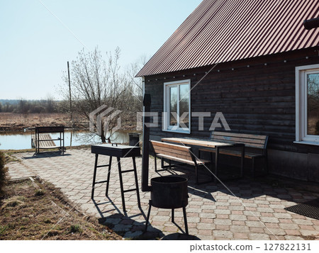A breathtaking scenic outdoor space featuring a rustic cabin alongside a serene water view A breathtaking scenic outdoor space featuring a rustic cabin alongside a serene water view 127822131