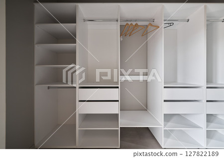 This is a modern design for a white closet that features both shelves and hangers effectively 127822189