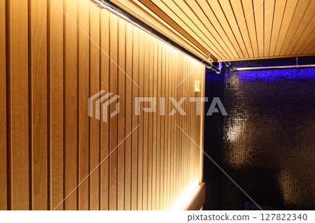 Stylish Wooden Wall with Soft Ambient Lighting Creates a Modern and Inviting Interior Space 127822340